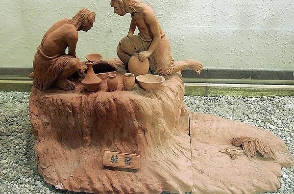 Sculpture of Ancient People Making Ceramics