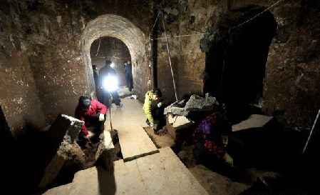 The file picture taken on Dec. 30, 2009 shows archaeologists clean up the archaeological site where the Mausoleum of Cao Cao is located in Anyang, a city in central China's Henan Province. The Mausoleum of Cao Cao, a legendary Chinese warlord during the Three Kingdoms period (208-280 A.D.), has recently been declared as Cultural Relics under Provincial Protection. The tomb is located near the Yellow River and the city of Anyang, where Cao Cao ruled the Kingdom of Wei from 208 to 220, when he died at the age of 65. 