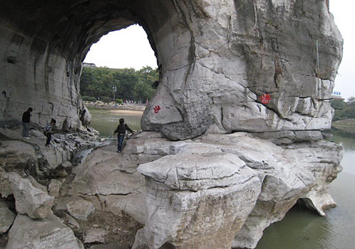 Tourists are exlporing the Moon over the Water Cave of the Elephant Trunk Hill by the Li River, Guilin