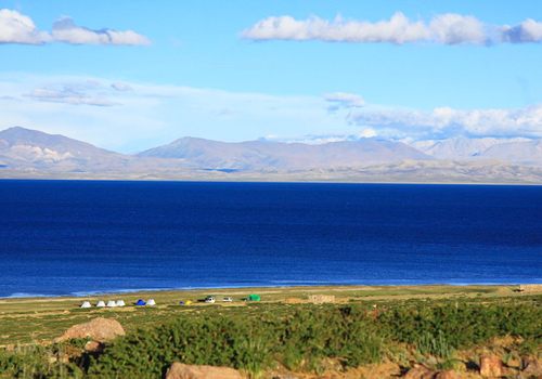 Traveler's tents dotted the shore of blue lake,Tibet