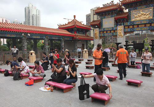 People are praying and drawing a lucky lot in Wong Tai Sin Temple of Hong Kong.