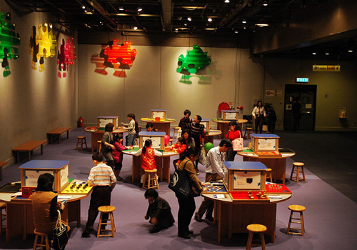 Kids are playing developmental games at a hall of Hong Kong Science Museum.