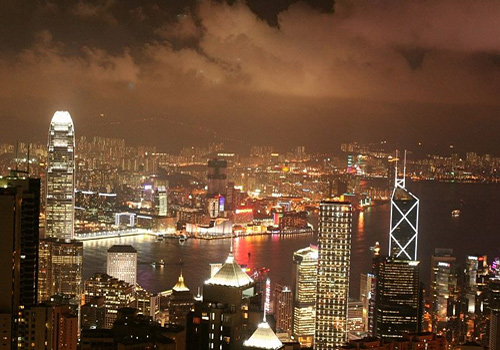 Brightly-lit city landscape of the Central from the top of Victoria Peak, Hong Kong.