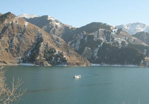 A toruist yacht is sailing on the Heavenly Lake,Urumqi attractions,Xinjiang.