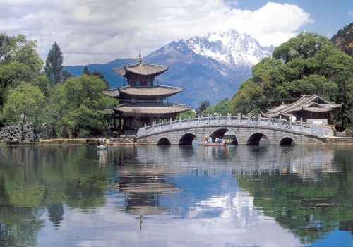 Beneath of the Great Stone Bridge,the reflection of Yulong Snow Mountain is visible in the water.