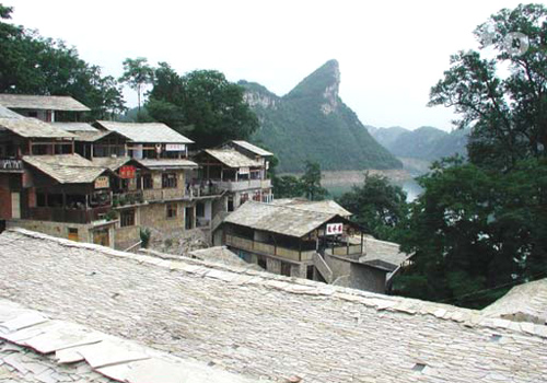 Zhenshan Ethnic Village in Guiyang features its primitive stone houses and ethnic minority customs.