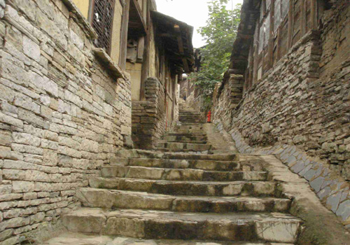 Zhenshan Ethnic Village in Guiyang looks just like a stone castle with stone gate tower, stone walls, stone houses and paved road.